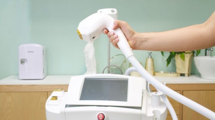 Close-up of a hand holding a laser hair removal device in a clinic setting. - Photo by ANVA Marketing on Pexels