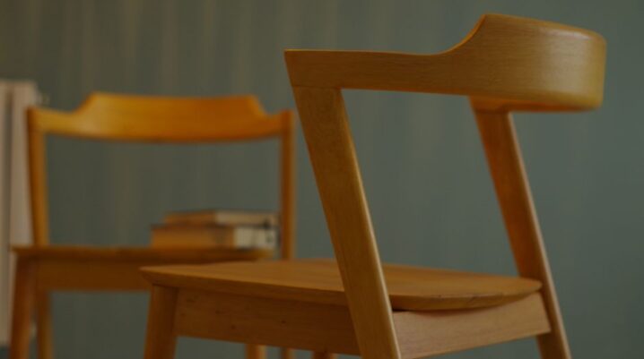 Modern wooden chairs with sleek design in an indoor minimalist setting. - Photo by Davide Armanti on Pexels