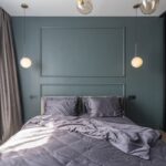 Interior design of modern bedroom with unmade bed under luminous lamps at sunlight - Photo by Max Vakhtbovych on Pexels