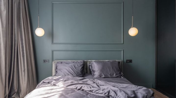 Interior design of modern bedroom with unmade bed under luminous lamps at sunlight - Photo by Max Vakhtbovych on Pexels