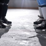 A close-up view of two pairs of ice skates on an ice rink, highlighting the skating gear. - Photo by Tony Schnagl on Pexels