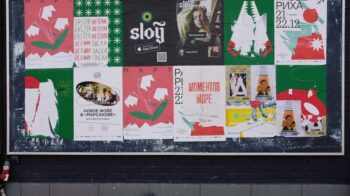 A vibrant urban bulletin board with a variety of colorful posters in Russian. - Photo by ready made on Pexels